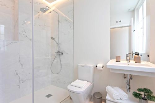 a bathroom with a shower and a toilet and a sink at Genteel Home Catedral in Cádiz