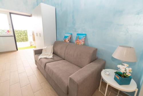a living room with a couch and a table at B&B DOMINUS in Scafati