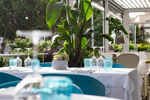 a table with a white table cloth and blue chairs at Villa Zaccardi in Rome