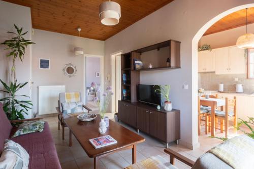 a living room with a couch and a table at Studio Dionphaie - Διόνφαιη in Pylos
