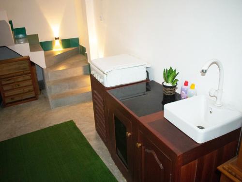 a bathroom with a sink and a counter with a sink at Piccolo Villa in Hikkaduwa