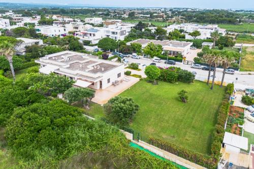 an aerial view of a large white building with a park at Villa Alba fronte mare in Carovigno