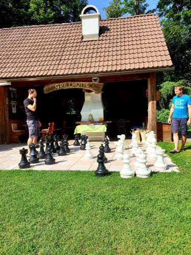 two men standing in front of a giant chessboard at Ferienparadies Truppe in Velden am Wörthersee