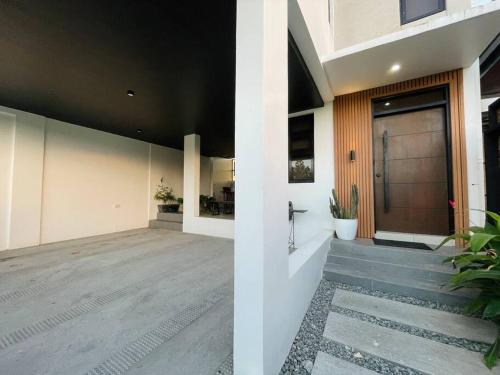 a hallway of a house with a door and stairs at Couple Room near Clark (Casa Isabela) in Mabalacat