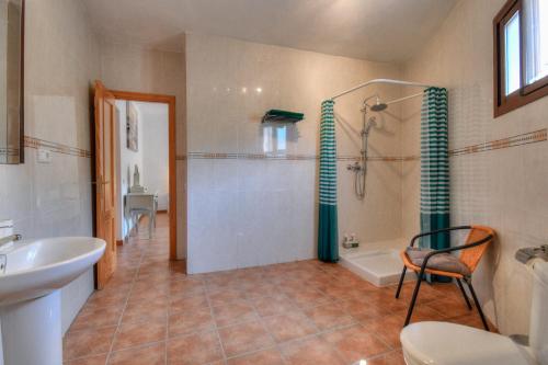a bathroom with a shower and a sink and a toilet at Casa Redonda in Cómpeta
