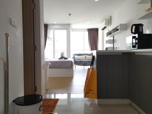 a room with a kitchen and a bedroom with a bed at 7 Floor - Ozone Condotel near Kata beach by 15 minutes walking in Kata Beach