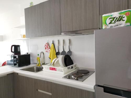 a kitchen with a sink and a stove and a refrigerator at 7 Floor - Ozone Condotel near Kata beach by 15 minutes walking in Kata Beach
