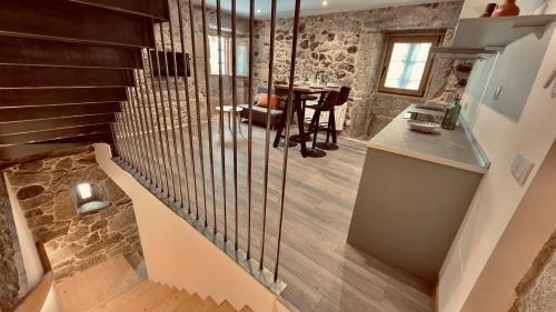 a staircase in a house with a stone wall at CASA MEIGO in Chantada