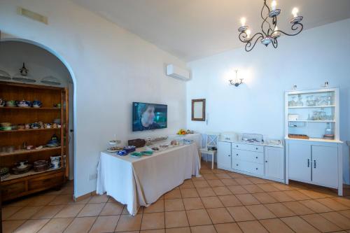 a blue room with a table and a counter and a kitchen at Solaria in Amalfi