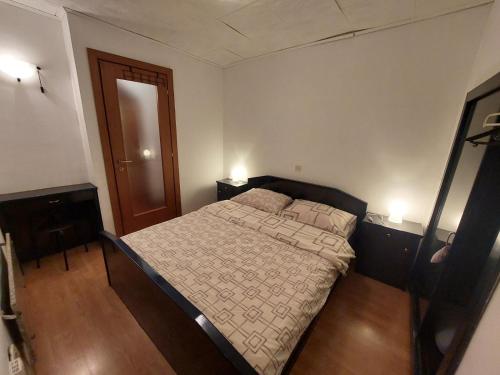a bedroom with a bed and two night stands and a mirror at Elim in Rovinj