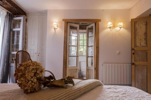 a bedroom with a bed and a window and a door at La Curva De María in Terán
