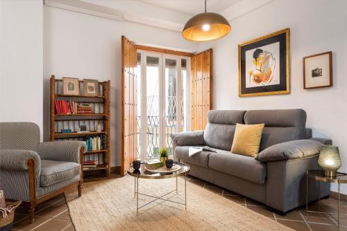 a living room with a couch and a table at Placentines in Seville