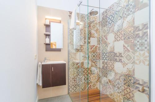 a bathroom with a glass shower with a sink at Finca Can Setri in Sant Llorenç des Cardassar