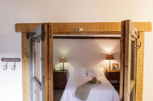 a bedroom with a large bed with a wooden frame at La Curva De María in Terán