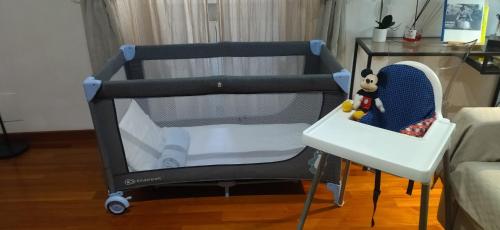 a baby crib in a room with a table at Pantheon Grand Suite in Rome