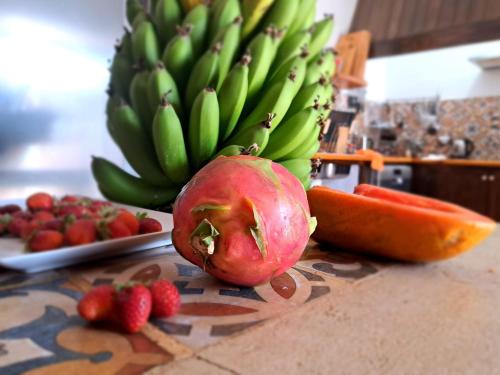a bunch of green bananas and strawberries on a counter at Finca Isolina Hotel Boutique - Adults Recommended in Mácher