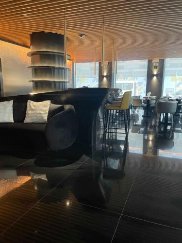 a living room with a couch and tables in a restaurant at Golden Lisbon Hotel in Lisbon