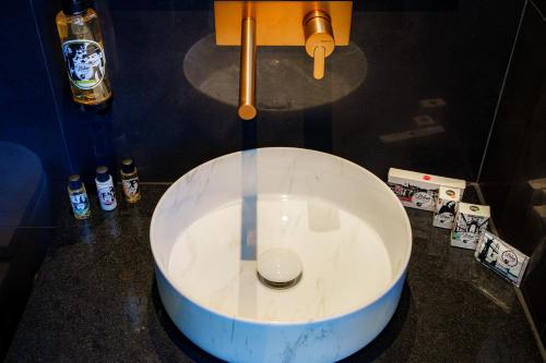 a bathroom with a white sink on a counter at Golden Lisbon Hotel in Lisbon