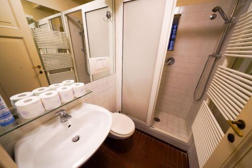 a bathroom with a sink and a toilet and a shower at Holiday House Naiadis in Rome