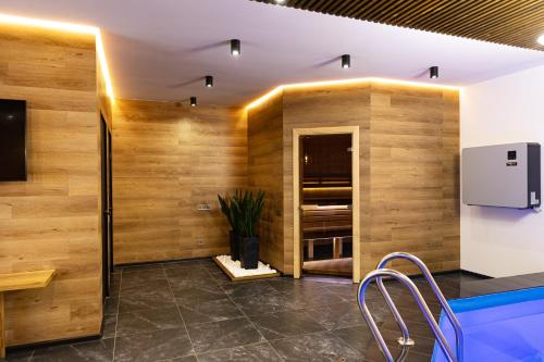a kitchen with wood paneling and a swimming pool at SVOI Hotel in Palyanytsya