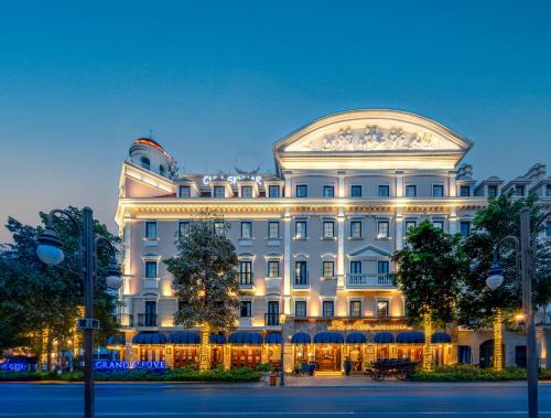 a large white building with a lit up facade at Grand Fleuve Boutique in Ha Long
