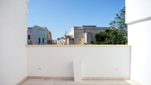 a white wall with a view of a city at Perla Suite in Mesagne