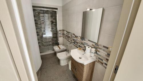 a bathroom with a sink and a toilet at Perla Suite in Mesagne