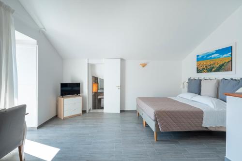 Ένα ή περισσότερα κρεβάτια σε δωμάτιο στο Casale del Nonno