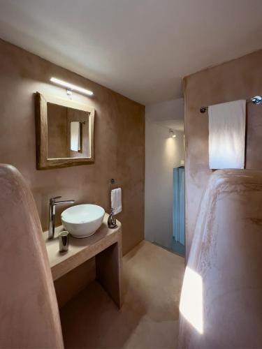 a bathroom with a sink and a mirror at Sirokos in Karavostasi