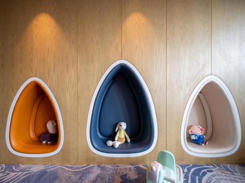 a wall with three little toy animals in three portals at Le Meridien Xi'an Chanba in Xi'an