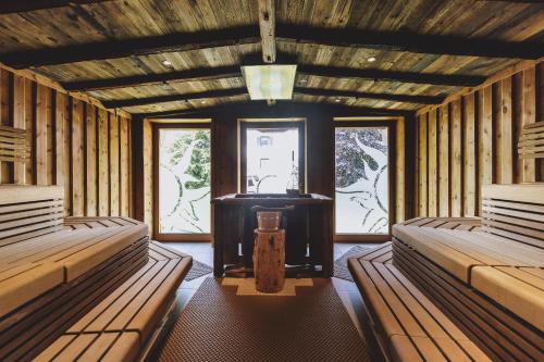 a large room with two beds and a window at Hotel DIE SONNE in Saalbach Hinterglemm