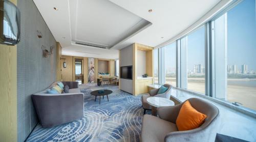 a hotel room with couches and a large window at Le Meridien Xi'an Chanba in Xi'an