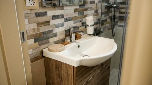 a bathroom with a sink and a shower at Perla Suite in Mesagne