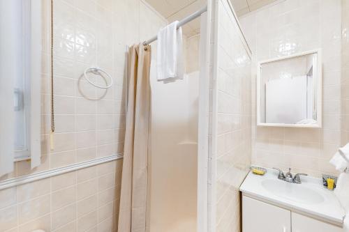 a bathroom with a shower and a sink at The Dockhouse Cottage Five in Wasaga Beach