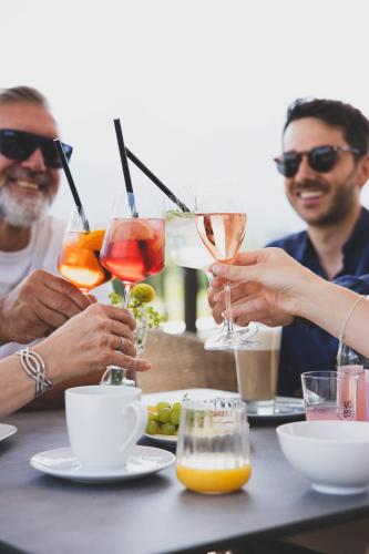 a group of people sitting at a table with drinks at TILL Naturhotel - Self-Check-In in Satteins
