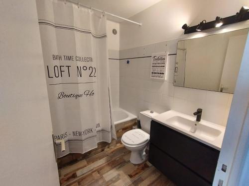 a bathroom with a toilet and a sink and a shower curtain at Sanary Paradise Port Climatisé in Sanary-sur-Mer