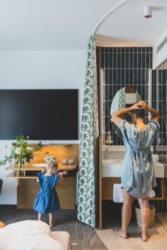 a woman standing in front of a mirror at TILL Naturhotel - Self-Check-In in Satteins