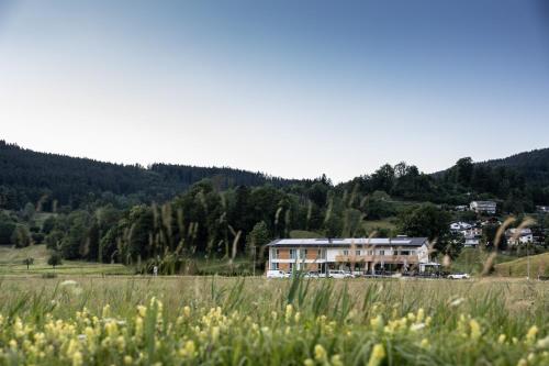 a large house in the middle of a field at TILL Naturhotel - Self-Check-In in Satteins