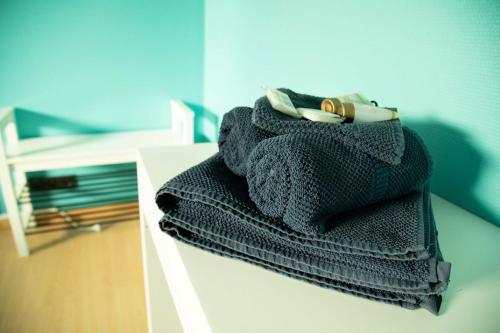 a pile of towels sitting on top of a table at Room "Carpe Diem" in Zele