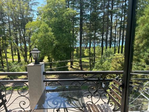 a balcony with a view of a park with trees at French Hotel in K'obulet'i