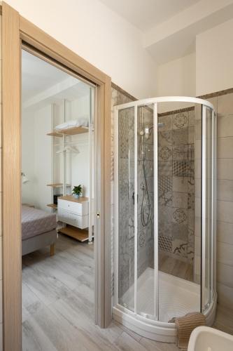 a glass shower in a room with a bedroom at Casale del Nonno in Sorrento