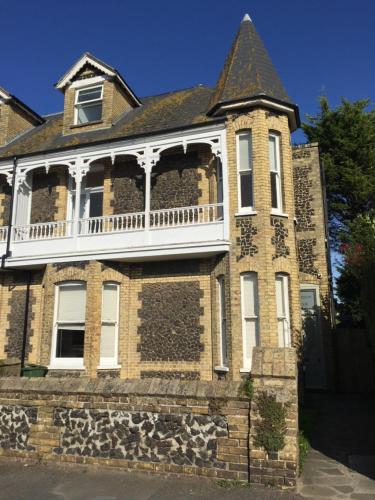 an old brick house with a turret at Hamilton Lodge: a 6 bedroom seaside Holiday Home hosting Happiness in Kent