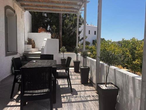 a patio with a table and chairs on a balcony at Traditional house in the heart of Naxos in Dhamariónas