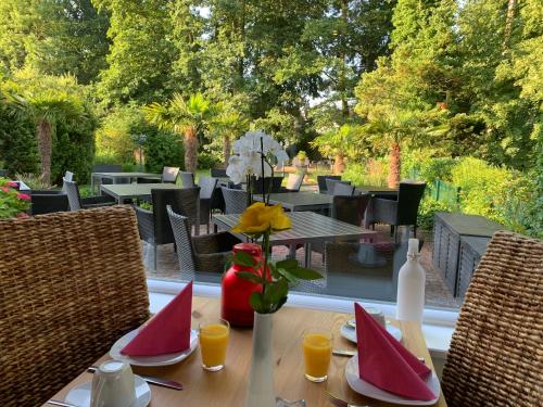 a table with a vase of flowers on top at Gästehaus Schwentineblick in Malente