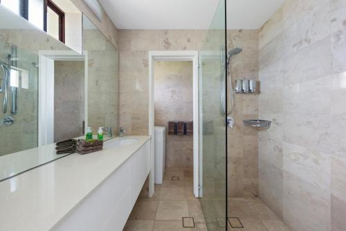 a bathroom with a sink and a shower at Waterfront on Manly Harbour in Sydney