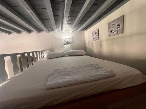 a large bed in a room with at Traditional house in the heart of Naxos in Dhamariónas