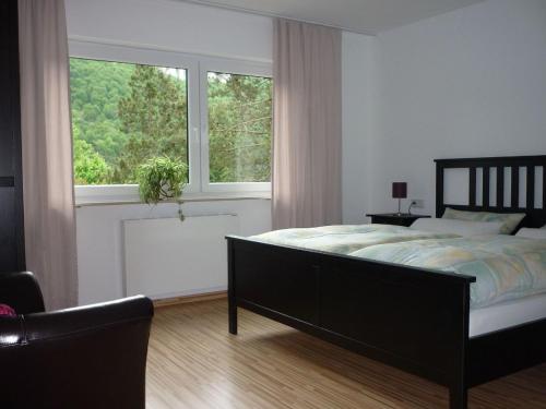 a bedroom with a bed and a large window at Fewo Larissa in Beuron