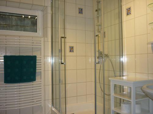 a bathroom with a shower with a glass door at Fewo Larissa in Beuron