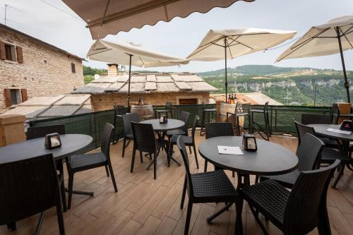 a patio with tables and chairs and umbrellas at BB Molina in Molina