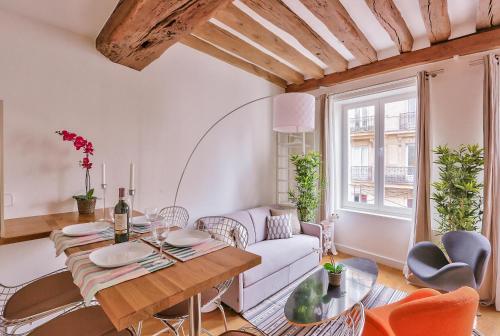 a living room with a table and a couch at St Michel - Deluxe Apartment - Harpe in Paris
